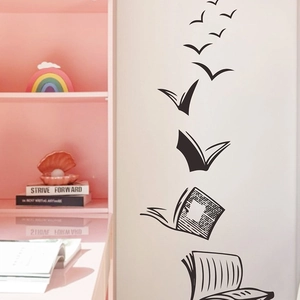 Creative black wall sticker featuring books transforming into birds for home decor