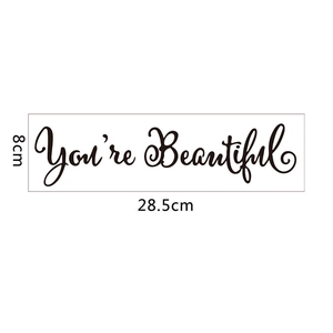 Macro detail of 'You're Beautiful' wall sticker with precise dimensions 28.5 x 8 cm