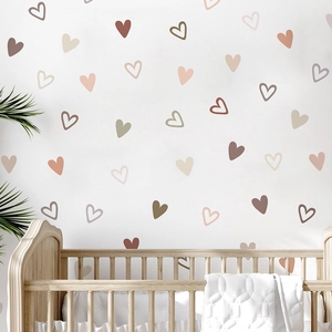 Morandi heart wall stickers in terracotta and beige tones over a wooden nursery crib