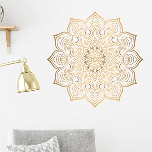 Large bohemian gold mandala wall sticker for bedroom decor over a grey sofa