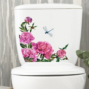 Detail of floral peony and dragonfly stickers applied on a white ceramic toilet tank