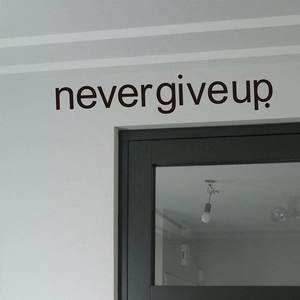 Inspirational Never Give Up wall decal above a bedroom door for modern home decoration