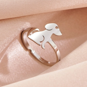 Polished stainless steel puppy silhouette open ring on elegant pink silk background