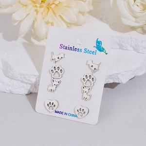 Set of 4 pairs of stainless steel dog heart stud earrings on display card with dried flowers