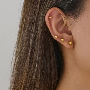 Polished golden stainless steel ball stud earrings in multiple sizes for cartilage piercing
