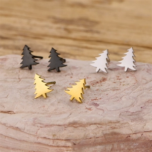 Three pairs of minimalist Christmas tree stud earrings in black, silver, and gold finish