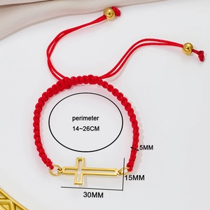 Adjustable red woven cord bracelet featuring a polished gold cross pendant for women