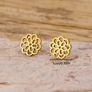 French retro gold cutout lotus stud earrings in stainless steel on a pink stone base