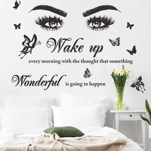 Detail of bedroom wall decal with eyelashes, butterflies and inspirational quote