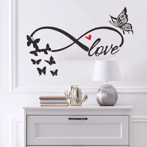 Black infinity love wall sticker with red heart and butterflies in cozy home setting