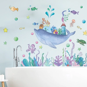 Cartoon whale and sea life wall stickers decorating a bathroom wall above a bathtub