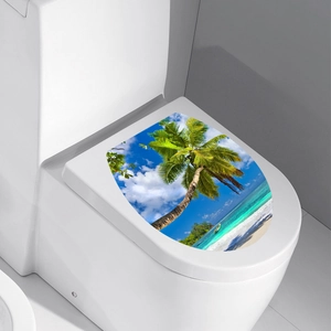 Detail view of tropical beach landscape sticker featuring palm trees on a white toilet lid