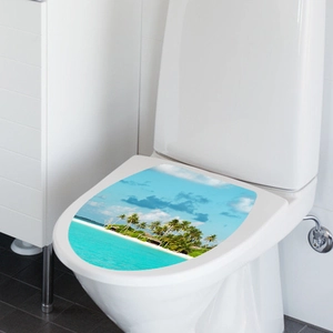 Detail view of tropical beach toilet seat decal with palm trees and ocean landscape