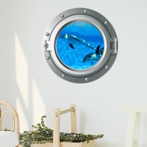 3D porthole wall decal featuring swimming dolphins in deep blue ocean for home decor