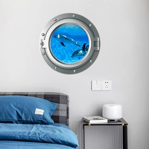 Detail view of 3D porthole wall sticker featuring dolphins in ocean for room decor