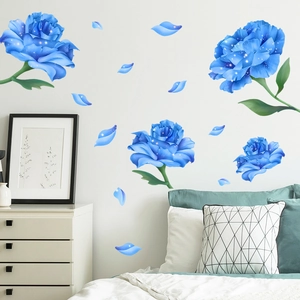 Detailed blue rose wall stickers with shimmering dots on a white bedroom wall
