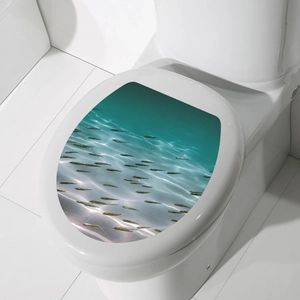 Waterproof PVC toilet lid sticker with ocean fish pattern on white ceramic surface