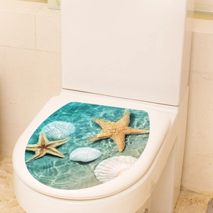 Detail of marine ocean theme toilet lid sticker with starfish and sea shells on white ceramic