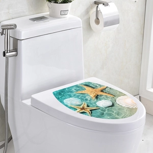 Close-up of waterproof PVC toilet sticker with starfish and sea shells in a modern bathroom