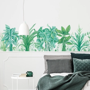 Detail of tropical monstera wall stickers applied on a white wall in a modern bedroom