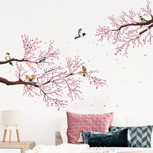 Detail of cherry blossom wall sticker with birds on a cozy bedroom background