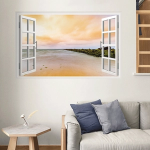 Modern 3D wall sticker with sunset beach view through an open window over a gray sofa