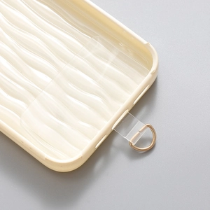 Clear TPU phone lanyard patch with golden D-ring on wavy beige phone case