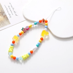 Close-up of colorful handmade beaded phone strap with fruit and bear charms