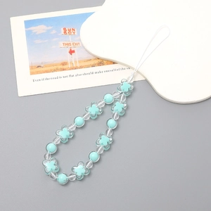 Detail of light blue flower beads and clear acrylic spheres on a beaded phone charm strap