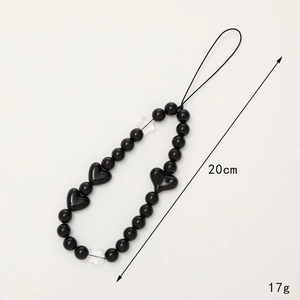 Handmade black and white beaded heart phone strap with star accents and 20cm length