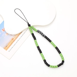 Detailed macro view of handmade beaded phone strap with green and black happy letter beads