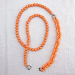 Detail of bright orange acrylic 2-in-1 crossbody phone chain with beads and thick links