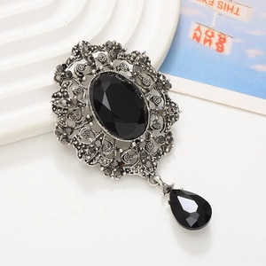 Baroque black gemstone pendant with silver alloy frame and droplet charm on white stand