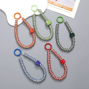 Detailed view of colorful rhinestone-beaded phone straps with sparkling crystal dice charms