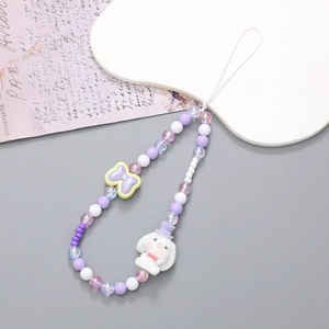 Cute beaded phone strap with purple bow and cartoon puppy charm on vintage paper