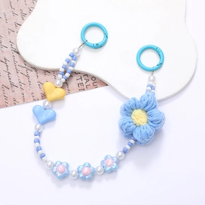 Detail of blue crochet flower and beaded heart charm strap with plastic rings