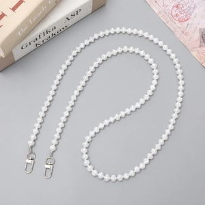 Elegant white floral pearl phone strap with silver lobster clasps on gray background