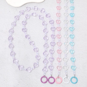 Detailed view of colorful acrylic heart bead chains with metallic paint clasps
