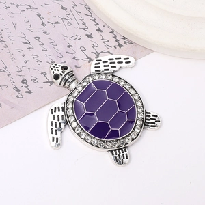 Detailed macro view of turtle charm with purple enamel and sparkling crystal accents