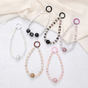 Detail view of colorful square beaded phone charms with assorted crystal and pearl styles