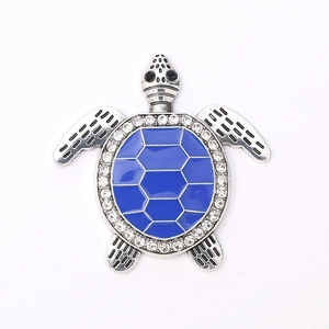 Macro shot of a sea turtle charm with blue enamel shell and sparkling crystal accents