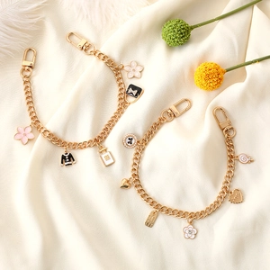 Elegant gold chain charm bracelet with flower, perfume bottle and heart pendants