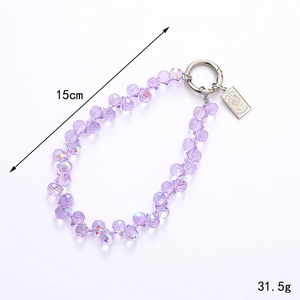 Iridescent purple crystal teardrop beaded charm with silver lobster clasp and queen tag