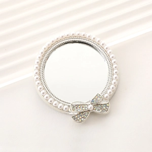 Elegant round mirror with pearl border and colorful rhinestone bow decoration charm