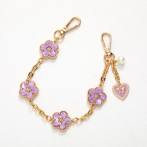 Golden chain strap with purple acetate flowers, heart pendant and white pearl charm