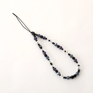 Close-up of crystal butterfly phone strap with purple faceted beads and letter C bead