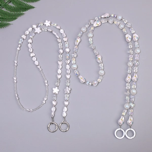 Handmade beaded chain with irregular pearls and colorful flower heart charms on grey background