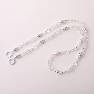 Detail of beaded phone strap with silver skull charms and iridescent heart beads