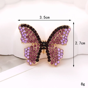 Dettaglio dell'accessorio farfalla con strass da 3,5 cm, cristalli viola e dimensioni