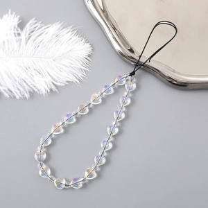 Iridescent heart beaded phone charm with aurora glow beads on silver tray decoration